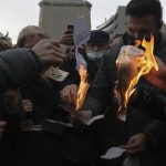 
              Members of Turkey's main opposition Republican People's Party burn invoices as they gather in front of a monument of the founder of modern Turkey, Mustafa Kemal Ataturk, in Ankara, Turkey, Wednesday, Feb. 9, 2022, to protest high electricity prices, as people set on fire electricity bills they say they can't pay. (AP Photo/Burhan Ozbilici)
            