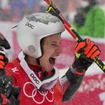 
              Marco Odermatt, of Switzerland, celebrates winning the gold medal in the men's giant slalom at the 2022 Winter Olympics, Sunday, Feb. 13, 2022, in the Yanqing district of Beijing. (AP Photo/Luca Bruno)
            