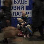 
              A woman with her daughter waits for a train as they try to leave at the Kyiv train station, Ukraine, Thursday, Feb. 24, 2022. Russian troops have launched their anticipated attack on Ukraine. Big explosions were heard before dawn in Kyiv, Kharkiv and Odesa as world leaders decried the start of an Russian invasion that could cause massive casualties and topple Ukraine's democratically elected government. (AP Photo/Emilio Morenatti)
            