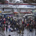 
              People try to get onto buses to leave Kyiv, Ukraine, Thursday, Feb. 24, 2022. Russia has launched a barrage of air and missile strikes on Ukraine early Thursday and Ukrainian officials said that Russian troops have rolled into the country from the north, east and south. (AP Photo/Emilio Morenatti)
            