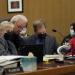 Scott Peterson, right, sits as attorneys Shelley Sandusky, from left, meets with Pat Harris and Cliff Gardner during a hearing at the San Mateo County Superior Court in Redwood City, Calif., Friday, Feb. 25, 2022. Peterson's chance for a new trial in the murder of his pregnant wife 20 years ago hinges on whether a California juror who helped convict him was biased. (AP Photo/Jeff Chiu, Pool)