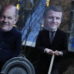 
              Climate activists wearing masks of German Chancellor Olaf Scholz, left, and French President Emmanuel Macron and holding shovels pose during an action in front of EU headquarters in Brussels, Wednesday, Feb. 2, 2022. Climate activists are denouncing today the expected inclusion by the European Commission of nuclear and gas in the list of green energies for investments in the energy sector. (AP Photo/Virginia Mayo)
            