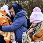 
              A mother hugs her daughter at a checkpoint run by local volunteers after arriving from Ukraine, crossing the border in Beregsurany, Hungary, Saturday, Feb 26, 2022. Hungary has extended legal protection to those fleeing the Russian invasion. (AP Photo/Anna Szilagyi)
            