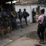 
              Riot policemen stand guard during an operation in the Villa Sarmiento shanty town in Buenos Aires, Argentina, Thursday, Feb. 3, 2022, where it is believed people may have purchased contaminated cocaine. A batch of cocaine that has killed at least 20 people in Argentina appears to have been laced with a synthetic opioid, and police are scrambling to get as much of it off the streets as they can. (AP Photo/Rodrigo Abd)
            