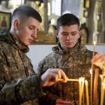
              Ukrainian Military Air Force University cadets light candles during a monthly memorial service for soldiers who were killed during the fighting against Russia-backed separatists in eastern Ukraine, in Kharkiv, Ukraine, Thursday, Feb. 3, 2022. Russia maintains it has no intention to attack its neighbor, but demands that NATO won't expand to Ukraine and other ex-Soviet nations or deploy weapons there. It also wants the alliance to roll back its deployments to Eastern Europe. (AP Photo/Evgeniy Maloletka)
            
