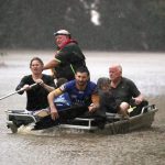 
              People use a small boat to travel through flood water in Lismore, Australia, Monday, Feb. 28, 2022. Heavy rain is bringing record flooding to some east coast areas and claimed seven lives while the flooding in Brisbane, a population of 2.6 million, and its surrounds is the worst since 2011 when the city was inundated by what was described as a once-in-a-century event. (Jason O'Brien/AAP Image via AP)
            
