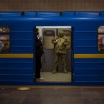 
              A Ukrainian army officer looks at his phone in a local train in Kyiv, Ukraine, Wednesday, Feb. 23, 2022. Ukraine urged its citizens to leave Russia as Europe braced for further confrontation Wednesday after Russia's leader received authorization to use military force outside his country and the West responded with a raft of sanctions. (AP Photo/Emilio Morenatti)
            