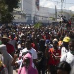
              Factory workers march to demand a salary increase in Port-au-Prince, Haiti, Wednesday, Feb. 23, 2022. It is the first day of a three-day strike organized by factory workers who also shut down an industrial park earlier this month to protest pay. (AP Photo/Odelyn Joseph)
            