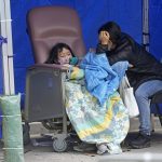 
              People, including current hospital patients, showing COVID-19 symptoms wait at a temporary holding area outside Caritas Medical Centre in Hong Kong Wednesday, Feb. 16, 2022. China's leader Xi Jinping took a personal interest in Hong Kong's recent outbreaks, saying it was the local government's "overriding task" to control the situation, a Hong Kong newspaper said on Wednesday. (AP Photo Vincent Yu)
            