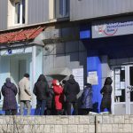 
              People line up to withdraw money from an ATM in Donetsk, the territory controlled by pro-Russian militants, eastern Ukraine, Monday, Feb. 21, 2022. World leaders are making another diplomatic push in hopes of preventing a Russian invasion of Ukraine, even as heavy shelling continues in Ukraine's east. (AP Photo/Alexei Alexandrov)
            
