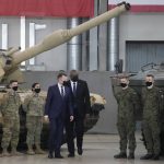 
              U.S. Defense Secretary Lloyd Austin, centre, and Poland's Defense Minister Mariusz Blaszczak walk, during a visit to U.S. troops stationed at the Powidz Air Base, in Poland, Friday, Feb. 18, 2022. Austin is in Europe for talks among fears in the West that Russia is planning to invade Ukraine, which borders NATO and European Union member Poland. (AP Photo/Czarek Sokolowski)
            