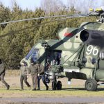 
              The Ukrainian delegation leaves a Belarusian military helicopter upon their landing in Gomel region, Belarus, Monday, Feb. 28, 2022. The Russian and Ukrainian delegations met for their first talks Monday. The meeting is taking place in Gomel region on the banks of the Pripyat River. (Sergei Kholodilin/BelTA Pool Photo via AP)
            