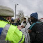 
              A police officer talks to refugees fleeing the conflict from neighbouring Ukraine at the Romanian-Ukrainian border, in Siret, Romania, Monday, Feb. 28, 2022. The European Union's commissioner for home affairs Ylva Johansson visited Romania's northern border crossing in Siret Monday where thousands of refugees are entering from neighboring Ukraine as they flee the conflict with Russia. (AP Photo/Andreea Alexandru)
            