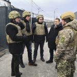 
              In this photo provided by Ukrainian Foreign Ministry Press Office, Czech, Slovak and Austrian foreign ministers Jan Lipavsky, Ivan Korcok and Alexander Schallenberg talk with a Ukrainian soldier during their visit to the border crossing between Ukraine and the territory controlled by pro-Russian militants in the Donetsk region, Ukraine, Monday, Feb. 7, 2022. (Ukrainian Foreign Ministry Press Office via AP)
            