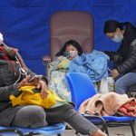
              People, including current hospital patients, showing COVID-19 symptoms wait at a temporary holding area outside Caritas Medical Centre in Hong Kong Wednesday, Feb. 16, 2022. China's leader Xi Jinping took a personal interest in Hong Kong's outbreak, saying it was the local government's "overriding task" to control the situation, a Hong Kong newspaper said on Wednesday. (AP Photo Vincent Yu)
            