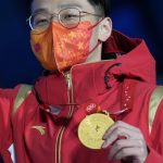 
              Ren Ziwei of China displays his gold medal during a medal ceremony for the men's 1,000-meter short track speedskating at the 2022 Winter Olympics, Tuesday, Feb. 8, 2022, in Beijing. (AP Photo/Natacha Pisarenko)
            
