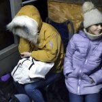 
              Two women sit inside a but waiting to be evacuated to Russia amid crisis in Donetsk, the territory controlled by pro-Russian militants, eastern Ukraine, Friday, Feb. 18, 2022. Spiking tensions in eastern Ukraine on Friday aggravated Western fears of a Russian invasion and a new war in Europe, with a humanitarian convoy hit by shelling and pro-Russian rebels evacuating civilians from the conflict zone. A car bombing hit the eastern city of Donetsk, but no casualties were reported. (AP Photo/Alexei Alexandrov)
            