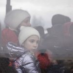 
              A child sits in a bus next to a woman after fleeing conflict in Ukraine, at the Medyka border crossing in Poland, Monday, Feb. 28, 2022. The head of the United Nations refugee agency says more than a half a million people had fled Ukraine since Russia’s invasion on Thursday. (AP Photo/Visar Kryeziu)
            