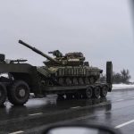 
              A military truck transports a platform with an Ukrainian tank near Kosyantynivka, eastern Ukraine, Tuesday, Feb. 8, 2022. French President Emmanuel Macron said Tuesday that Russian President Vladimir Putin told him he would not further escalate the Ukraine crisis in their marathon talks in the Kremlin a day earlier. (AP Photo/Evgeniy Maloletka)
            