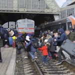 
              People gather to catch a train and leave Ukraine for neighboring countries at the railway station in Lviv,western Ukraine, Saturday, Feb. 26, 2022. The U.N. refugee agency says nearly 120,000 people have so far fled Ukraine into neighboring countries in the wake of the Russian invasion. The number was going up fast as Ukrainians grabbed their belongings and rushed to escape from a deadly Russian onslaught. (AP Photo/Mykola Tys)
            
