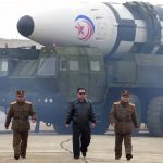 
              In this photo distributed by the North Korean government, North Korean leader Kim Jong Un, center, walks around what it says a Hwasong-17 intercontinental ballistic missile (ICBM) on the launcher, at an undisclosed location in North Korea on March 24, 2022. Independent journalists were not given access to cover the event depicted in this image distributed by the North Korean government. The content of this image is as provided and cannot be independently verified. Korean language watermark on image as provided by source reads: "KCNA" which is the abbreviation for Korean Central News Agency. (Korean Central News Agency/Korea News Service via AP)
            