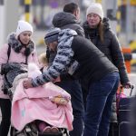 
              Refugees from Ukraine cross into Poland at the Medyka crossing, Tuesday, March 1, 2022. Ambassadors from dozens of countries on Monday backed a proposal demanding that Russia halt its attack on Ukraine, as the U.N. General Assembly held a rare emergency session during a day of frenzied and sometimes fractious diplomacy surrounding the five-day-old war. (AP Photo/Markus Schreiber)
            