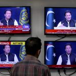 
              A man watches news channels broadcast a live address to the nation by Pakistan's Prime Minister Imran Khan, in Islamabad, Pakistan, Thursday, March 31, 2022. Pakistan's embattled Prime Minister Khan remained defiant on Thursday, telling the nation that he will not resign even as he faces a no-confidence vote in parliament and the country's opposition says it has the numbers to push him out. (AP Photo/Anjum Naveed)
            