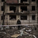 
              A Ukrainian firefighter walks outside a destroyed building after it was hit by artillery shelling in Kyiv in Kyiv, Ukraine, Monday, March 14, 2022. (AP Photo/Felipe Dana)
            