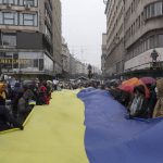 
              People hold a giant Ukrainian flag during a protest against the Russian invasion of Ukraine, in Belgrade, Serbia, Sunday, March 6, 2022 (AP Photo/Marko Drobnjakovic)
            