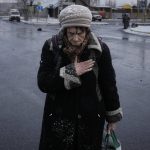 
              An elderly lady pauses after fleeing Irpin, on the outskirts of Kyiv, Ukraine, Tuesday, March 8, 2022. Demands for ways to safety evacuate civilians have surged along with intensifying shelling by Russian forces, who have made significant advances in southern Ukraine but stalled in some other regions. Efforts to put in place cease-fires along humanitarian corridors have repeatedly failed amid Russian shelling. 
 (AP Photo/Vadim Ghirda)
            