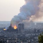 
              FILE - Notre Dame cathedral is burning in Paris, on April 15, 2019. French President Emmanuel Macron pledged to rebuild Paris' beloved Notre Dame Cathedral "even more beautifully" after a raging fire destroyed its spire and its roof but spared most of the structure, including the church's twin medieval bell towers. French President Emmanuel Macron has formally announced that he will seek a second term in April’s presidential election.  (AP Photo/Rafael Yaghobzadeh, FILE)
            