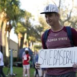 
              Baseball fan Noah McMurrain of Boynton Beach, Fla., stands outside Roger Dean Stadium as Major League Baseball negotiations continue in an attempt to reach an agreement to salvage a March 31 start to the regular season, Monday, Feb. 28, 2022, in Jupiter, Fla. (AP Photo/Lynne Sladky)
            