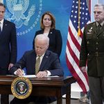
              President Joe Biden signs a delegation of authority in the South Court Auditorium on the White House campus in Washington, Wednesday, March 16, 2022. From left, Secretary of State Antony Blinken, Biden, Deputy Secretary of Defense Kathleen Hicks and Chairman of the Joint Chiefs of Staff General Mark Milley. (AP Photo/Patrick Semansky)
            