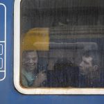 
              People fleeing the war from neighboring Ukraine looks on from a train window, in Zahony, Hungary, Wednesday, March 2, 2022. Some of Ukraine’s most vulnerable citizens have reached safety in Poland through an effort of solidarity and compassion that transcended borders and raised a powerful counterpoint to war. On Wednesday, a train pulled into the station in Zahony, Hungary carrying some 200 people with severe physical and mental disabilities. The refugees, most of them children, were residents of two orphanages for the disabled in Ukraine’s capital of Kyiv that were evacuated as Russian forces battered the city. (AP Photo/Balazs Kaufmann)
            