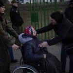 
              An older woman, who has fled Ukraine is reunited after arriving at the border crossing in Medyka, Poland, Sunday, March 13, 2022. Now in its third week, the war has forced more than 2.5 million people to flee Ukraine. (AP Photo/Daniel Cole)
            