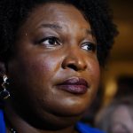 
              Georgia gubernatorial Democratic candidate Stacey Abrams talks to the media after qualifying for the 2022 election on Tuesday, March 8, 2022, in Atlanta. Abrams has no announced opposition for governor for the Democratic nomination. (AP Photo/Brynn Anderson)
            