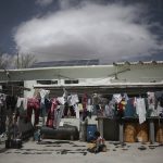
              A child rides a toy car under a clothesline in a courtyard of the Good Samaritan shelter in Juarez, Mexico, Tuesday, March 29, 2022. The vast majority of people staying at the shelter are women and their children from Mexico and Central America who have been expelled under Title 42 authority or were still waiting to try for asylum, according to Pastor Juan Fierro, the shelter’s director.  (AP Photo/Christian Chavez)
            