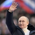 
              Russian President Vladimir Putin waves people after delivering his speech at the concert marking the eighth anniversary of the referendum on the state status of Crimea and Sevastopol and its reunification with Russia, in Moscow, Russia, Friday, March 18, 2022. (Ramil Sitdikov/Sputnik Pool Photo via AP)
            