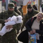 
              People fleeing from Ukraine are helped by Slovakia's army soldiers to cross the border in Vysne Nemecke, Slovakia, Friday, March 4, 2022. More than 1 million people have fled Ukraine following Russia's invasion in the swiftest refugee exodus in this century, the United Nations said Thursday. (AP Photo/Darko Vojinovic)
            
