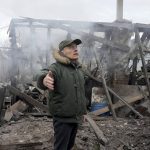 
              A man opens his arms as he stands near a house destroyed in the Russian artillery shelling, in the village of Horenka close to Kyiv, Ukraine, Sunday, March 6, 2022. On Day 11 of Russia's war on Ukraine, Russian troops shelled encircled cities, and it appeared that a second attempt to evacuate civilians from the besieged port city of Mariupol had failed due to continued violence. (AP Photo/Efrem Lukatsky)
            