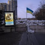 
              An advertising billboard in front of a barricade in Kyiv, Ukraine, Monday, March 21, 2022. (AP Photo/Rodrigo Abd)
            