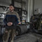 
              Car welder Ostap Datsenko, 31, pauses during an interview at a welding workshop in Lviv, western Ukraine, Sunday, March 27, 2022. Datsenko says he was ready like all Ukrainian men to be called up to fight. But he had no combat experience, meaning his time was yet to come. Until then, he said, “I’m doing what I can.” (AP Photo/Nariman El-Mofty)
            