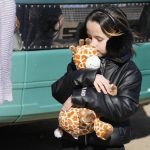 
              A refugee girl hugs her toy giraffe after fleeing the war from neighbouring Ukraine, at the border crossing in Palanca, Moldova, Saturday, March 19, 2022. (AP Photo/Sergei Grits)
            