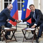 
              FILE - French President Emmanuel Macron, right, shakes hands with Russian President Vladimir Putin after their meeting at the fort of Bregancon in Bormes-les-Mimosas, southern France, on Aug. 19, 2019. French President Emmanuel Macron invited Russian President Vladimir Putin to his summer residence at the Fort de Bregancon, on the French Riviera, in a rare honor meant to give a boost to peace talks with Ukraine during summer 2019. French President Emmanuel Macron has formally announced that he will seek a second term in April’s presidential election. 
 (Gerard Julien, Pool via AP, File)
            