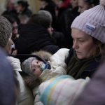 
              A woman holds he baby after fleeing the conflict from neighboring Ukraine at the Przemysl train station in Przemysl, Poland, Wednesday, March 9, 2022. (AP Photo/Daniel Cole)
            