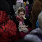 
              A woman who fled the war from neighboring Ukraine wait at the Przemysl train station in Przemysl, Poland, Wednesday, March 9, 2022. (AP Photo/Daniel Cole)
            
