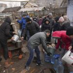 
              People line up to get water at the well in outskirts of Mariupol, Ukraine, Wednesday, March 9, 2022. A Russian attack has severely damaged a maternity hospital in the besieged port city of Mariupol, Ukrainian officials say. (AP Photo/Evgeniy Maloletka)
            
