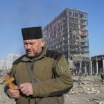 
              A priest prays by the ruins of a destroyed shopping center after shelling, in Kyiv, Ukraine, Monday, March 21, 2022. (AP Photo/Efrem Lukatsky)
            