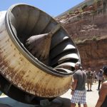 
              FILE - In this June 21, 2015 photo, tourists look up at an old turbine runner during a tour of Glen Canyon Dam, which impounds Lake Powell, in Page, Ariz. The elevation of Lake Powell fell below 3,525 feet (1,075 meters), a record low that surpasses a critical threshold at which officials have long warned signals their ability to general hydropower is in jeopardy. (AP Photo/Felicia Fonseca, File)
            