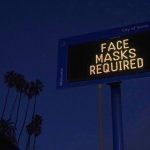 
              FILE - A sign reminding people to wear a mask stands along the Pacific Coast Highway in Santa Monica, Calif., Tuesday, Dec. 8, 2020. (AP Photo/Jae C. Hong, File)
            